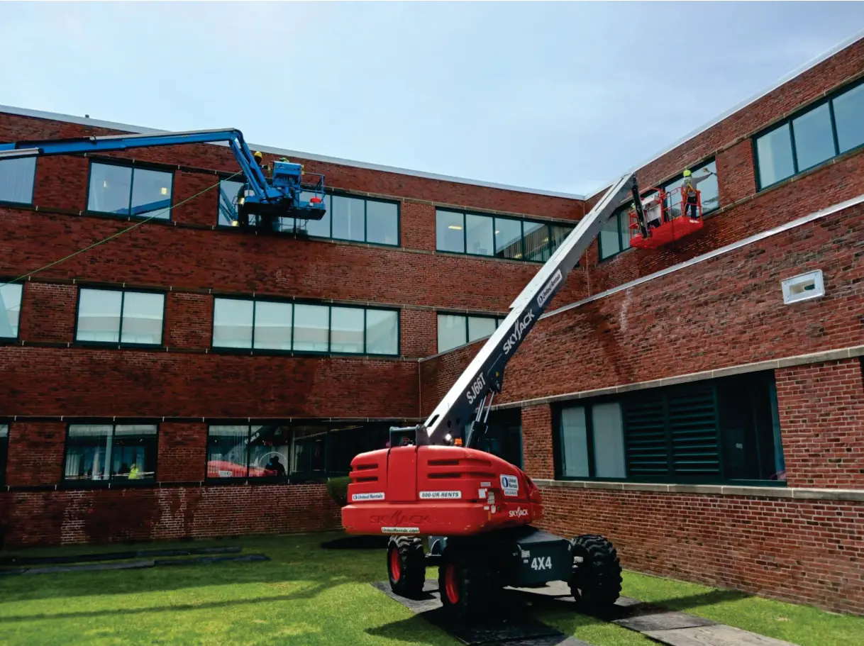 Aerial lift masonry restoration of a brick commercial building at 300 Baker, Boston